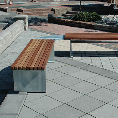 Wooden bench combination which meet creating a corner seat outdoors.